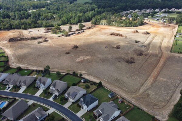 In-progress sitework at Lamb Farm residential community in Duncan, SC, with grading, utilities, and infrastructure preparation for 110 single-family homes by S3 Construction